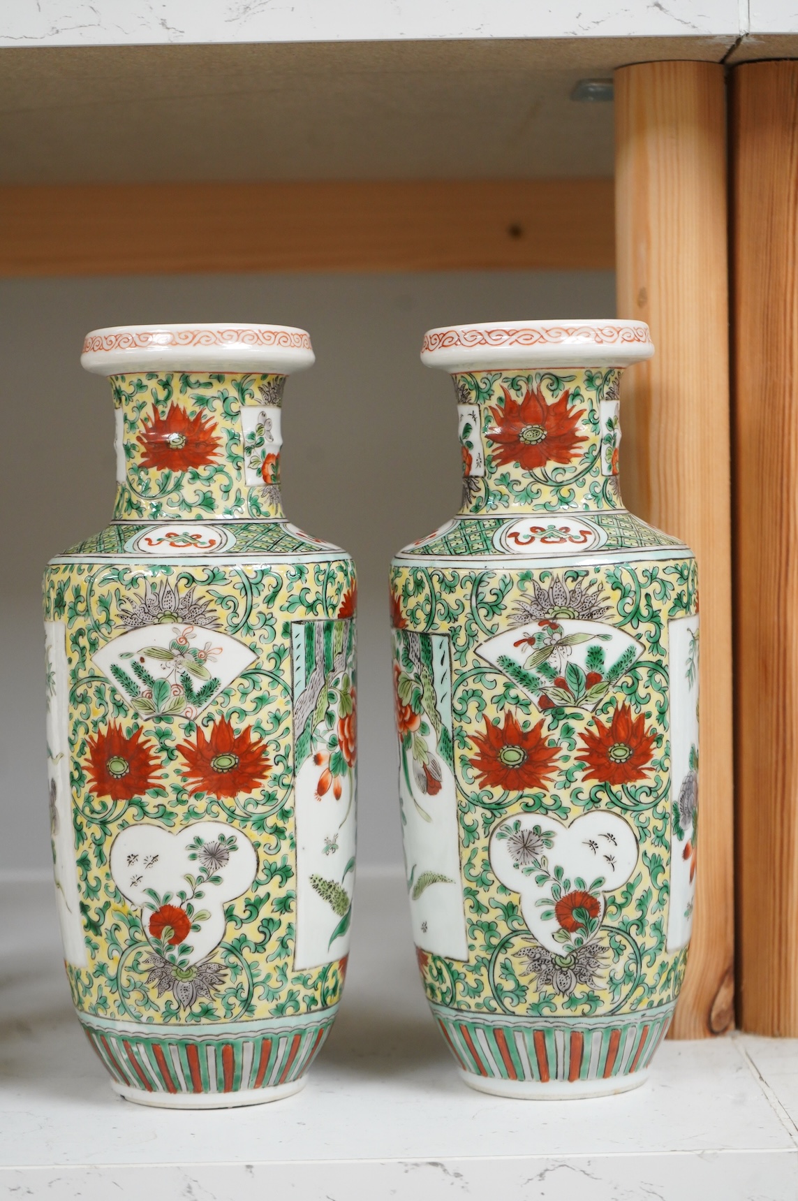 A pair of Chinese famille verte rouleau vases, enamelled with flowers, 25cm high